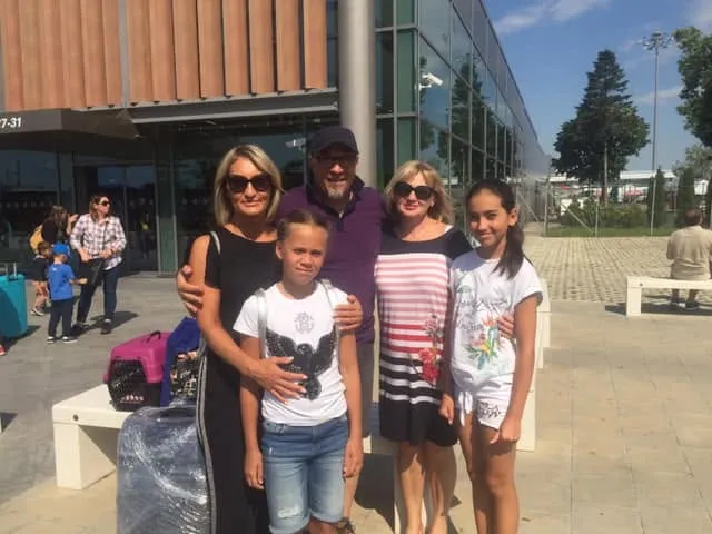 Family meeting their airport transfer driver outside the terminal